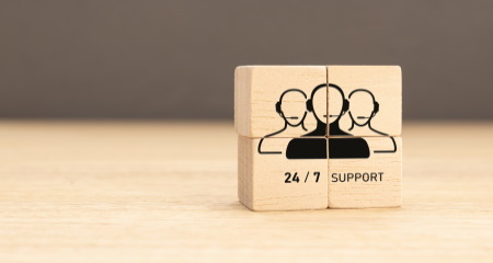24-7 Customer support concept. Group of wooden block with Group of Call Center Workers icon. Copy space